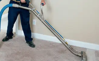Professional operating a liquid removal machine on a carpeted floor in Hialeah, FL